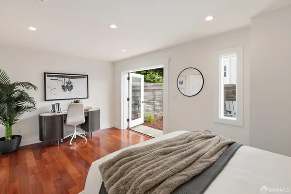 a bedroom with bed and a large window