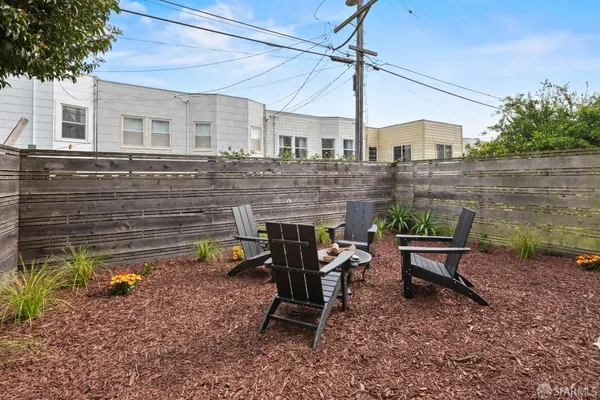 a view of a patio with a table and chairs
