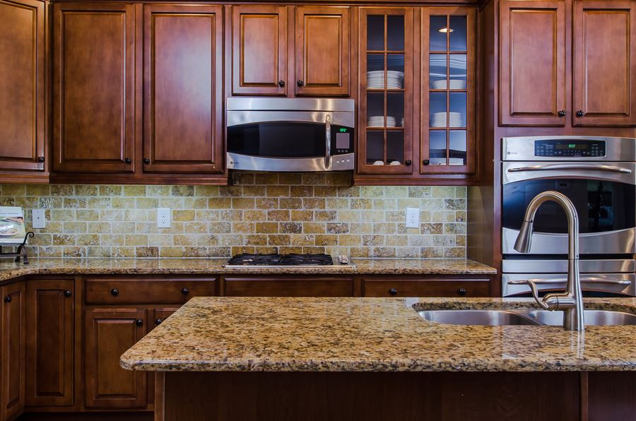 1407 Van Page Boulevard Raleigh, NC 27607 - Photo 10 of 25 Kitchen island features a generous sink along with granite countertops and a seating area for easy serving. Kitchen