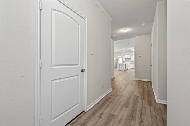 a view of hallway with wooden floor