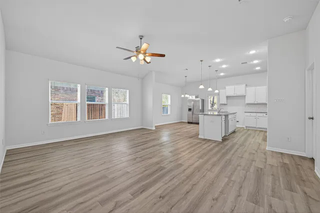 a view of a kitchen with a sink and wooden floor