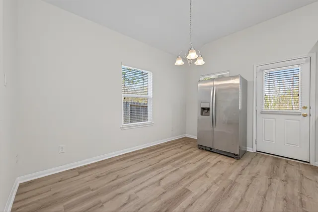 a view of kitchen with granite countertop cabinets and stainless steel appliances