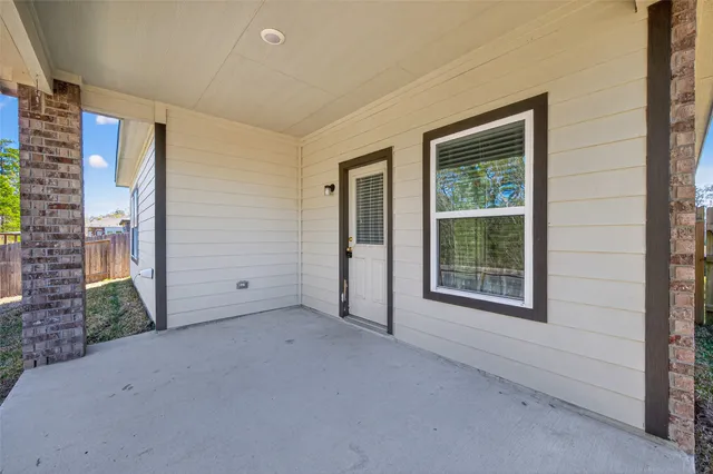 a view of backyard with wooden fence