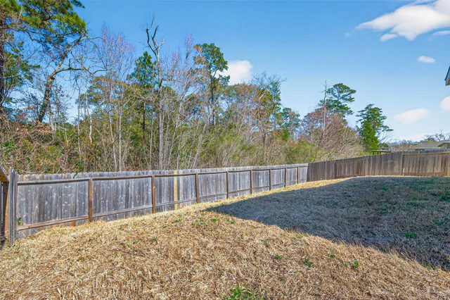 a view of an empty room with a fireplace and a window