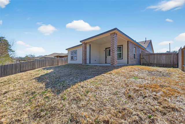 a view of small yard with wooden fence