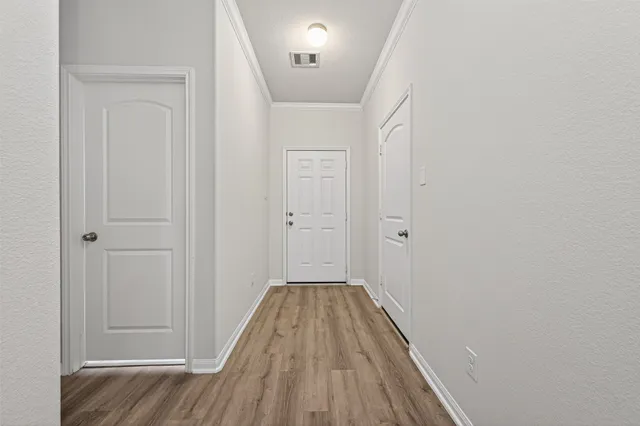 a view of a hallway with wooden floor