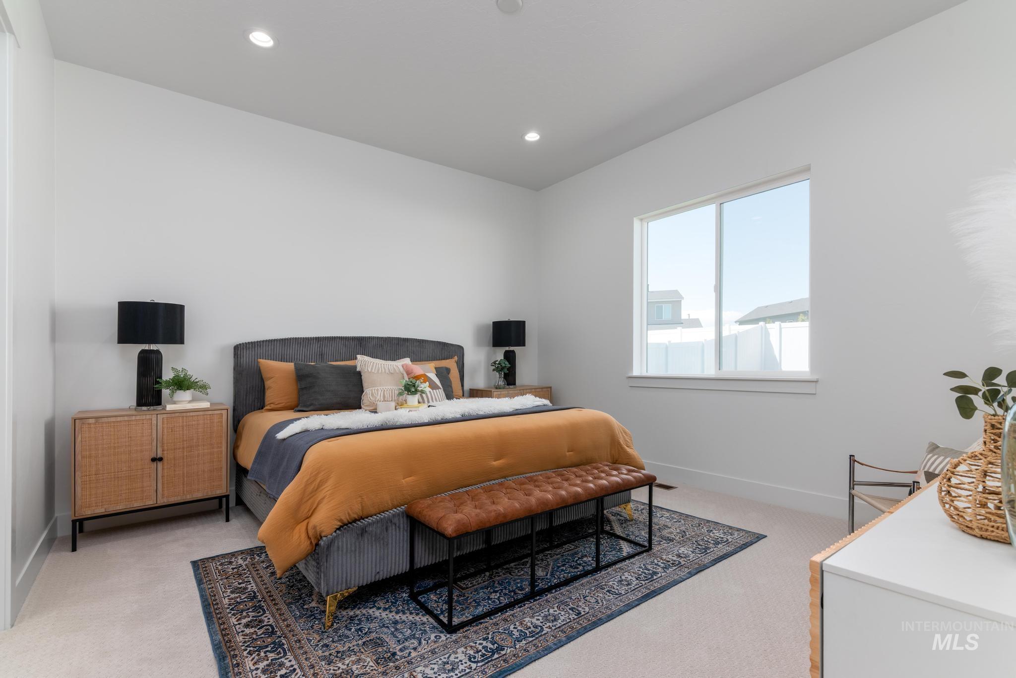 8501 South Country Wind Avenue Meridian, ID 83642 - Photo 18 of 39 Carpeted bedroom featuring a large window, recessed lighting, and white baseboards