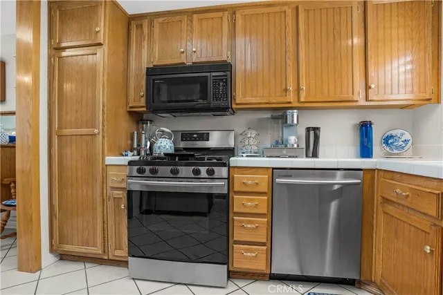 a kitchen with stainless steel appliances granite countertop a stove and a microwave