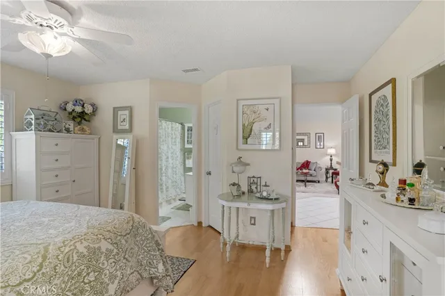 a spacious bedroom with a bed and a dresser in it