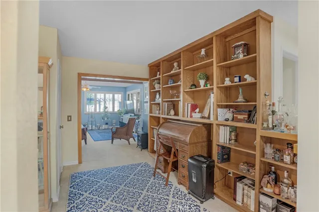 a living room with a bookshelf and a large window