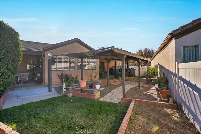 a patio table and chairs with potted plants