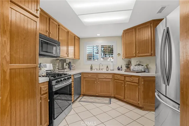 a kitchen with stainless steel appliances granite countertop a stove top oven a sink and dishwasher
