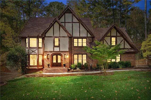 a view of a house with a yard and sitting area