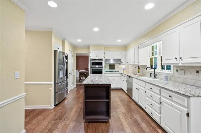 a living room with furniture a fireplace and large windows