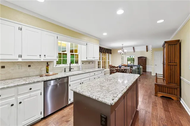 a living room with furniture and a ceiling fan