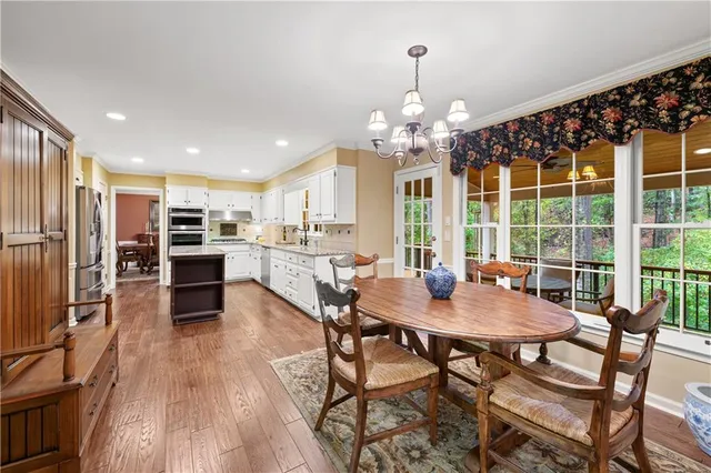 a work room with furniture and large windows