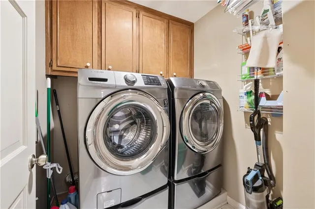a view of a hallway with a livingroom and a bathroom with a sink