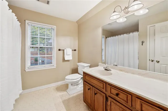 a bathroom with a glass shower door and a window