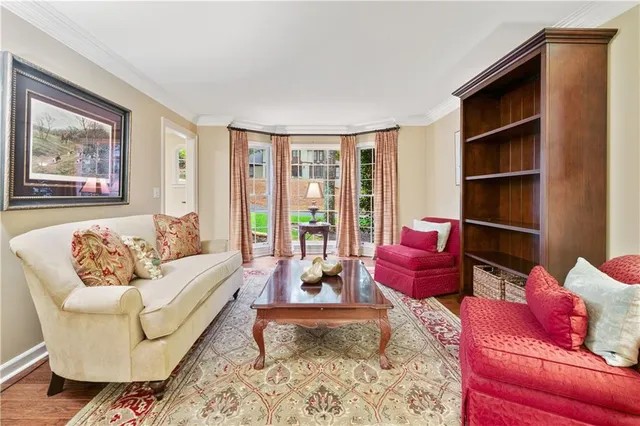 a living room with furniture a wooden floor and a table