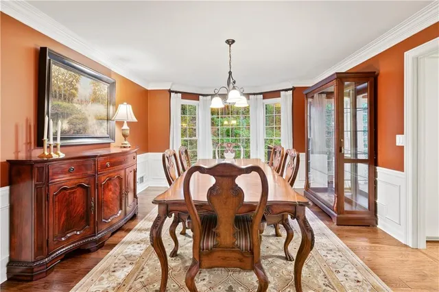 a kitchen with granite countertop white cabinets and window