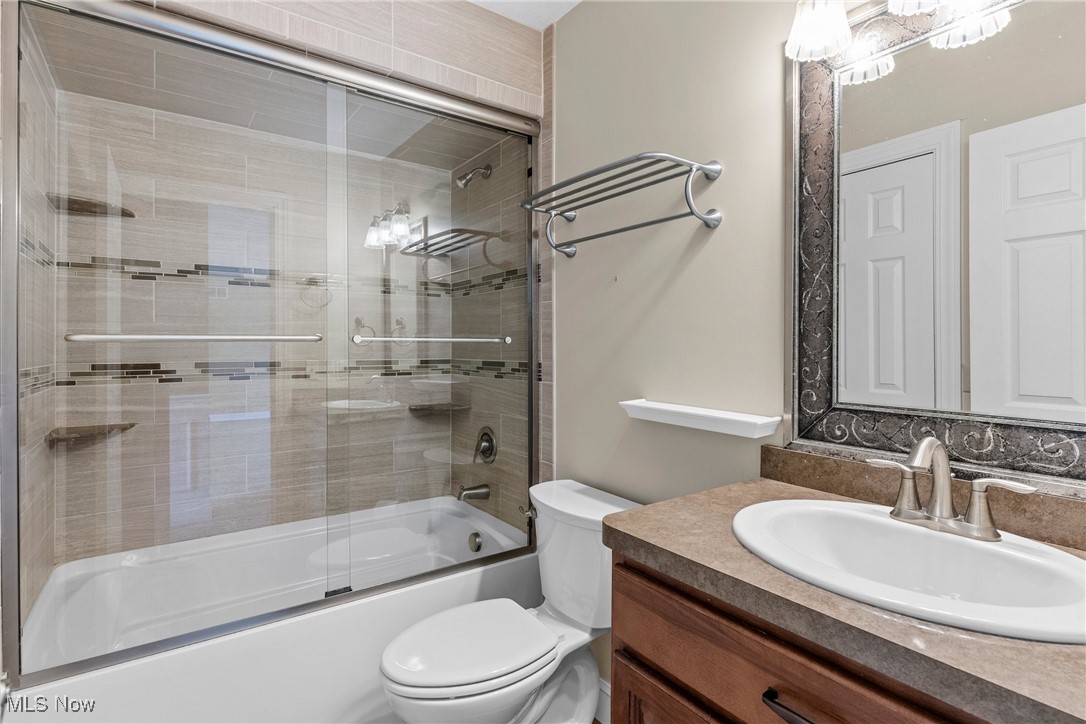 5215 River Road Madison, OH 44057 - Photo 23 of 36 Bathroom featuring shower / bath combination with glass door and vanity