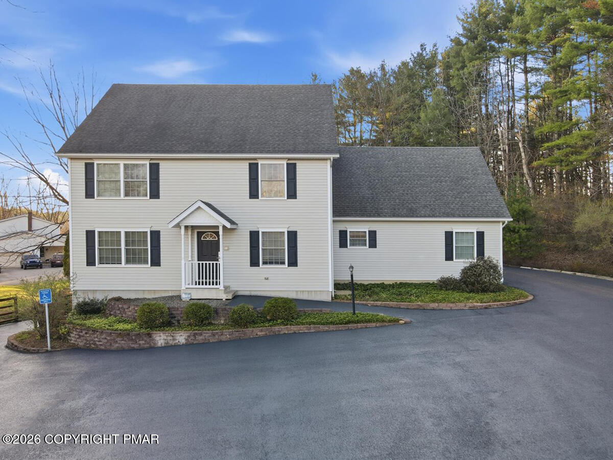457 Hickory Valley Road Stroudsburg, PA 18360 - Photo 6 of 50 a front view of a house with a garden and yard