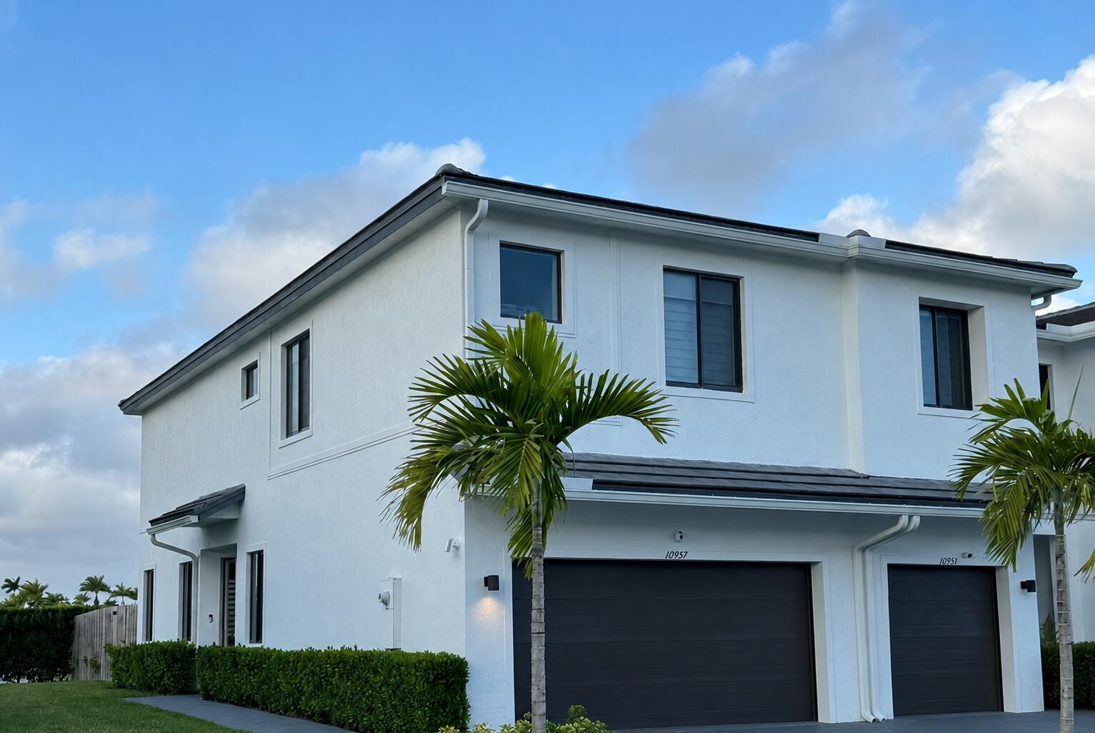 a house that has a palm tree in front of it