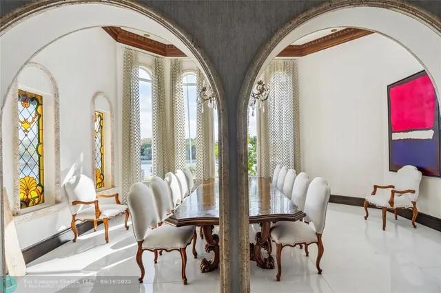 a living room with furniture and floor to ceiling windows