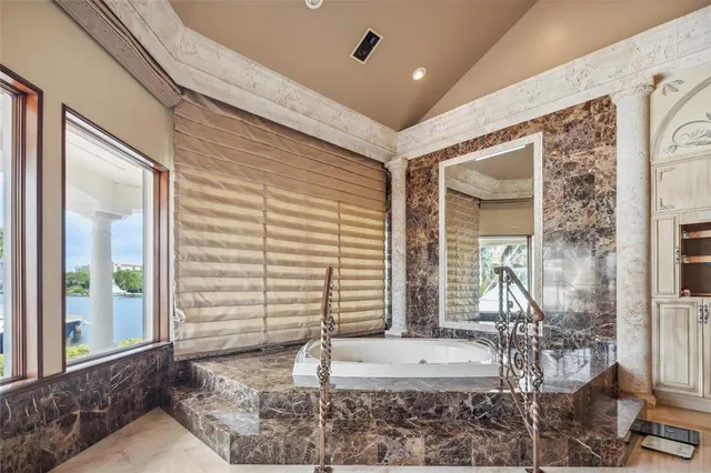 a bedroom with furniture and a large window