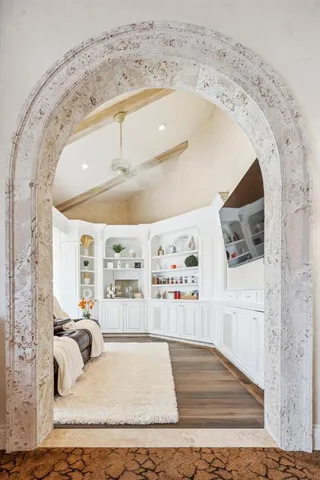 a bedroom with furniture and large windows