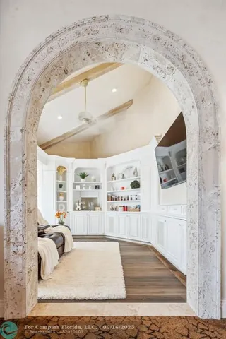 a bedroom with furniture and large windows