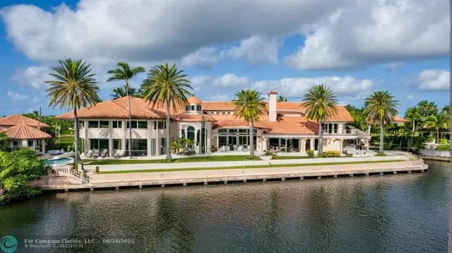 an aerial view of residential houses with lake view