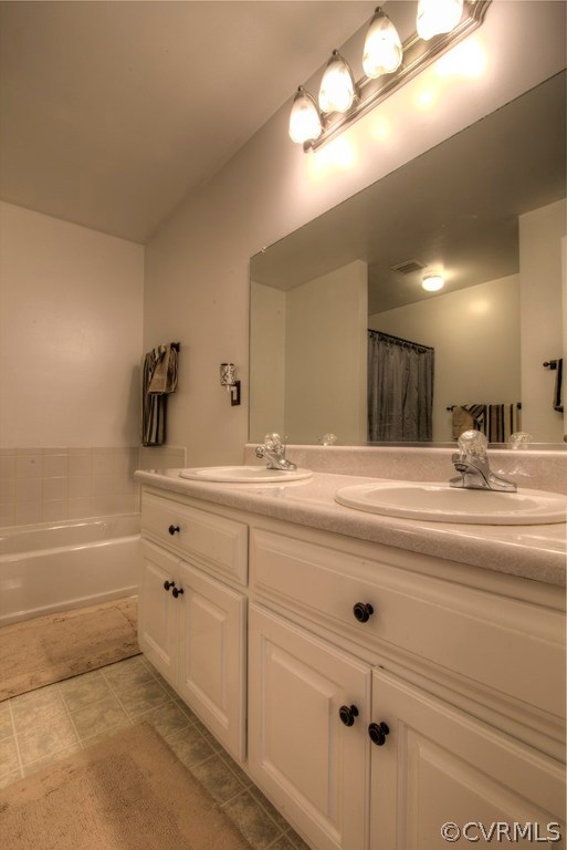 12607 Balta Road Chesterfield, VA 23838 - Photo 6 of 27 a bathroom with a sink a large mirror and vanity