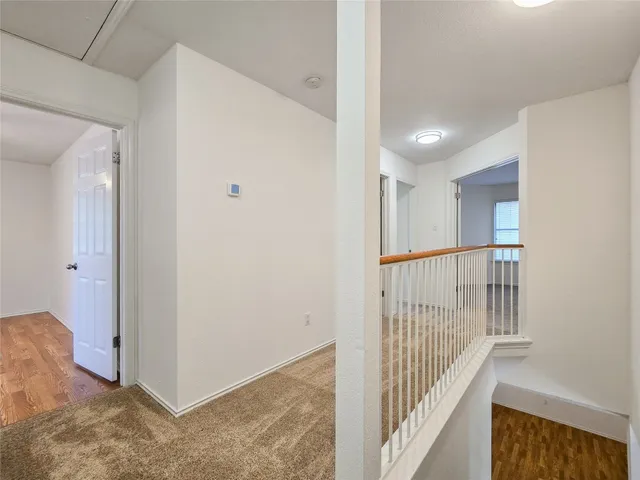 a view of a hallway with wooden floor and entryway