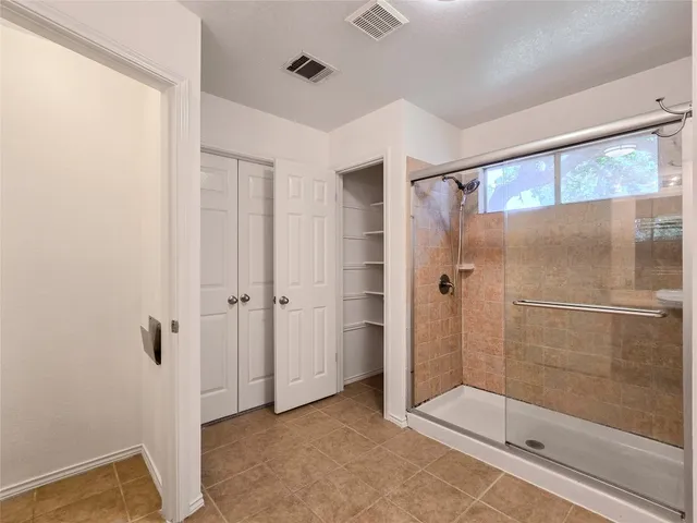 a bathroom with a shower and a sink