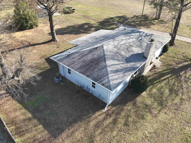 a view of a dry yard with mountains in the background