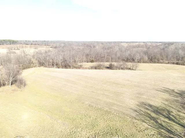 an empty room with a fireplace and window