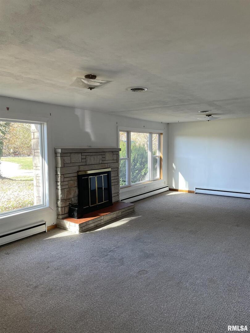 17726 Quiet Acres Road Scheller, IL 62883 - Photo 6 of 19 an empty room with a fireplace and window