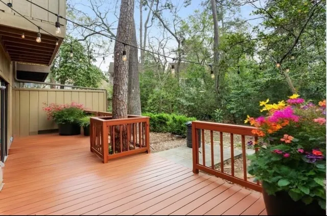 a view of balcony with wooden floor and outdoor seating