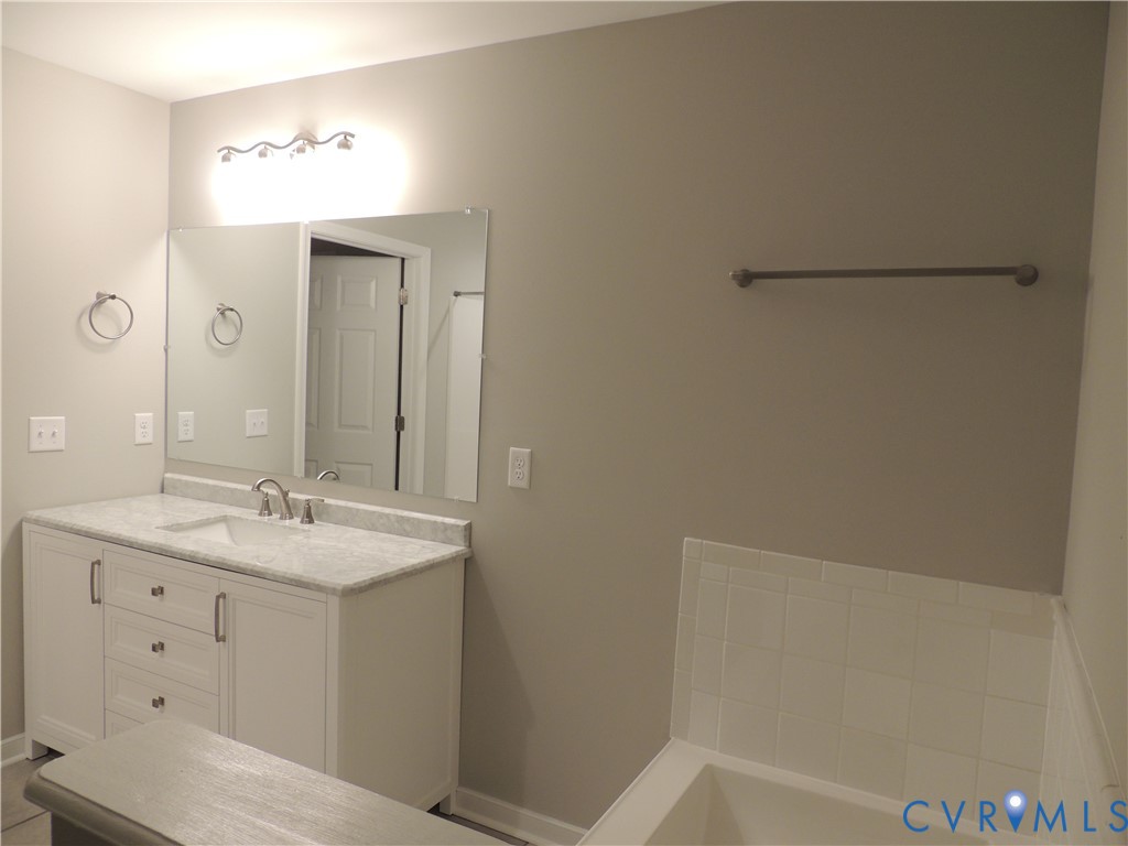 4417 Olgers Road Sutherland, VA 23885 - Photo 15 of 24 Bathroom vanity featuring a white cabinetry, light