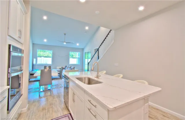 a large white kitchen with a table and chairs