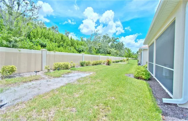 a view of a backyard with pathway