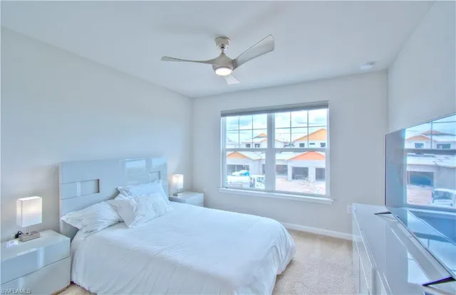 a bedroom with a large bed and a large window