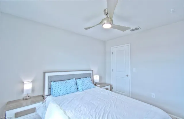 a bedroom with a bed and a lamp