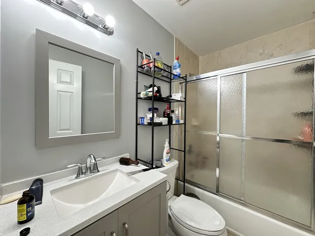 a bathroom with a sink toilet and shower