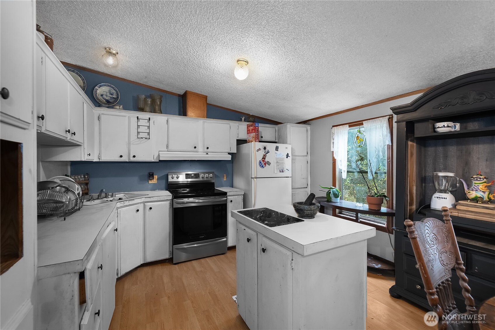 310 East Olde Lyme Road Shelton, WA 98584 - Photo 2 of 34 a kitchen that has a lot of cabinets a sink and a stove