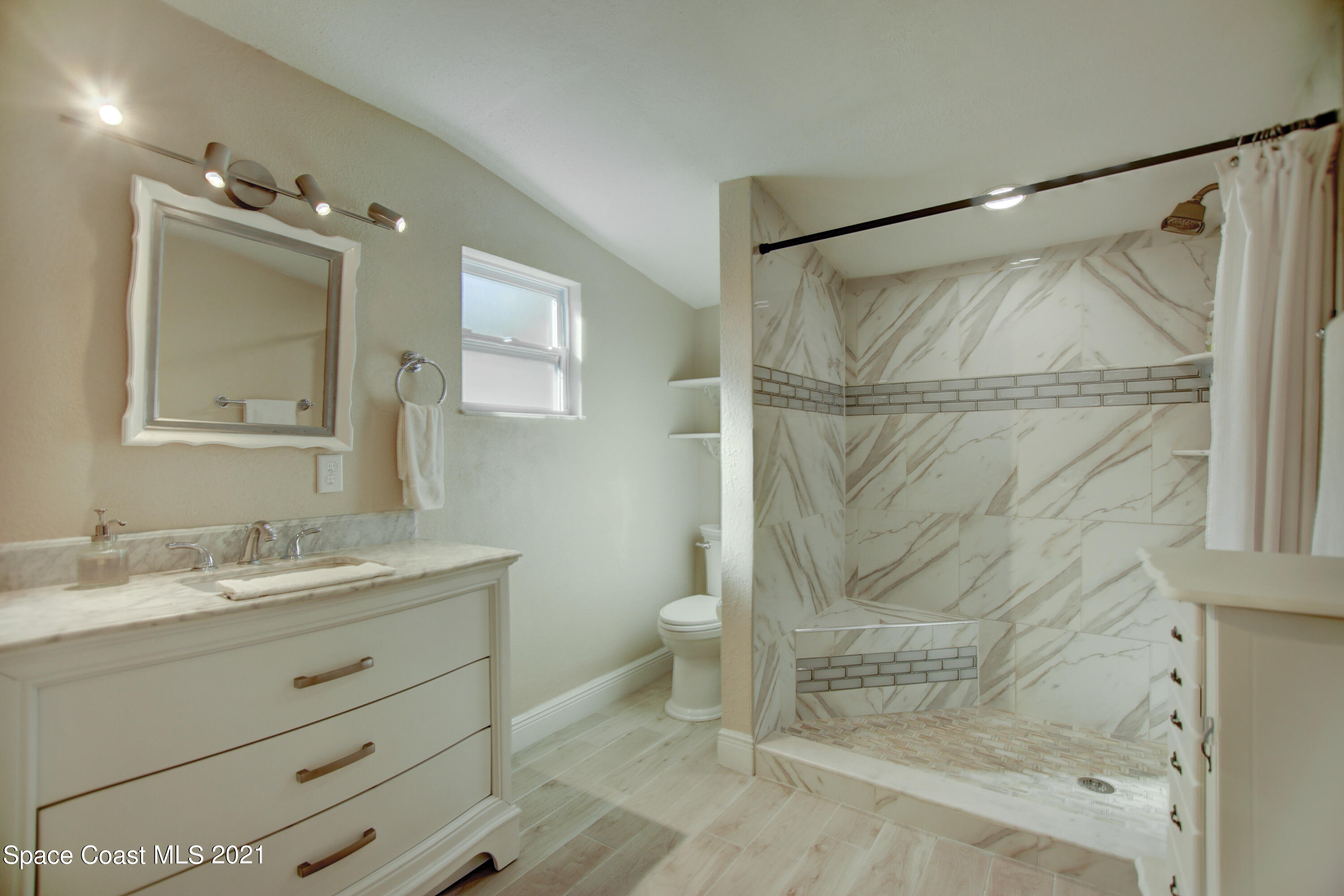 1896 Keewin Avenue Palm Bay, FL 32905 - Photo 11 of 23 a bathroom with a granite countertop sink toilet and shower