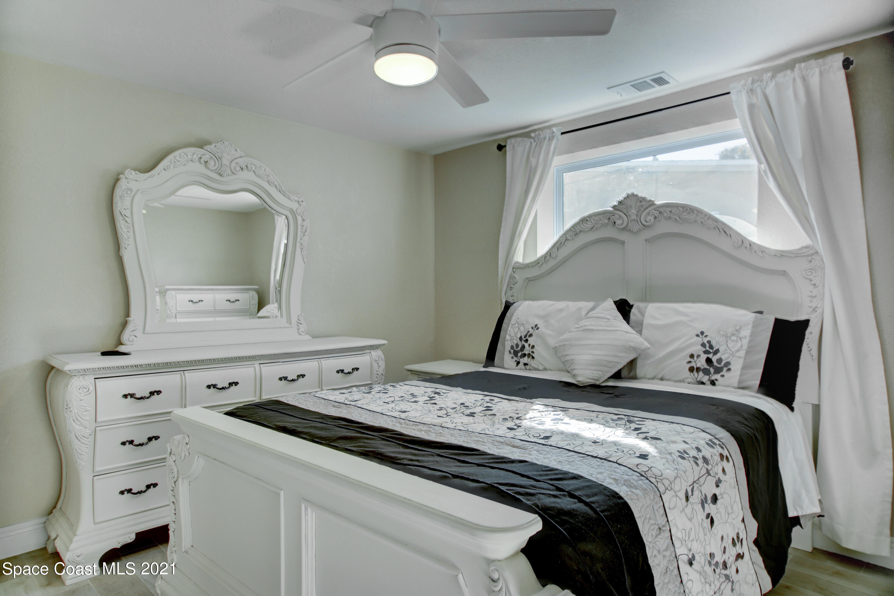 1896 Keewin Avenue Palm Bay, FL 32905 - Photo 12 of 23 a bedroom with a bed and a mirror