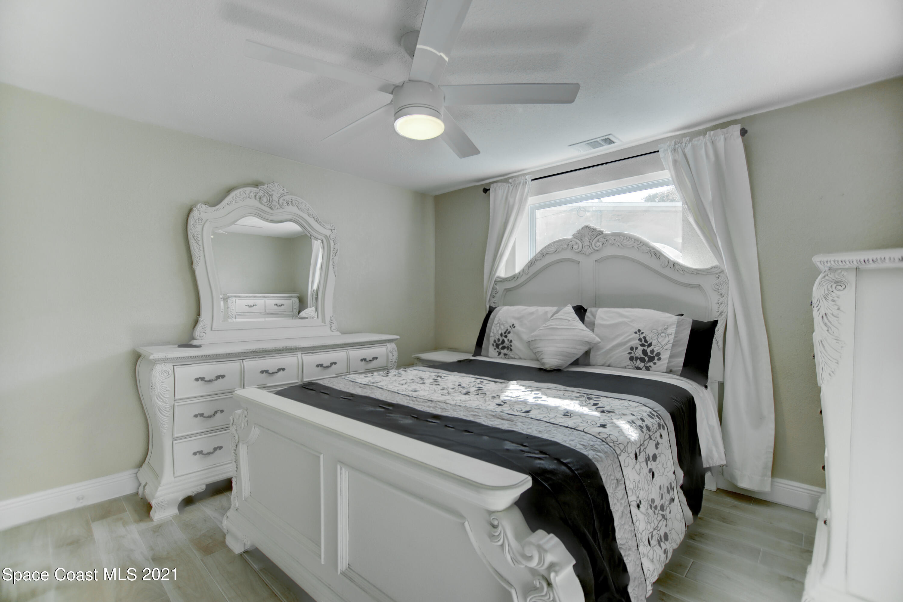 1896 Keewin Avenue Palm Bay, FL 32905 - Photo 13 of 23 a bedroom with a bed and a dresser