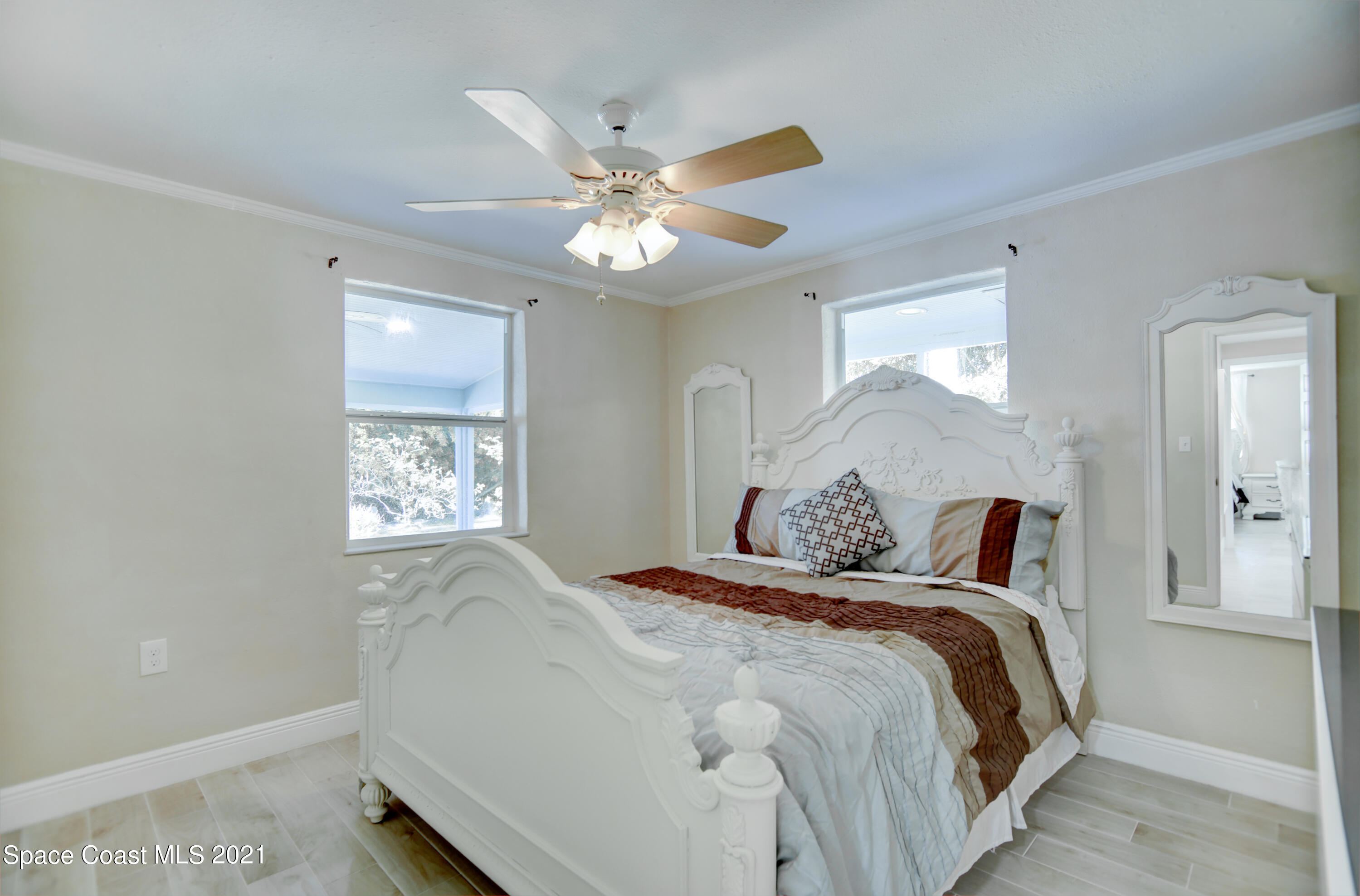 1896 Keewin Avenue Palm Bay, FL 32905 - Photo 14 of 23 a bedroom with a bed and a chandelier